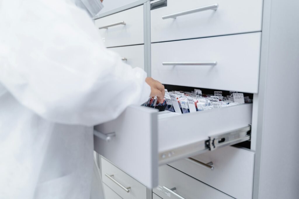 A healthcare professional accesses medical files in a sterile laboratory setting.